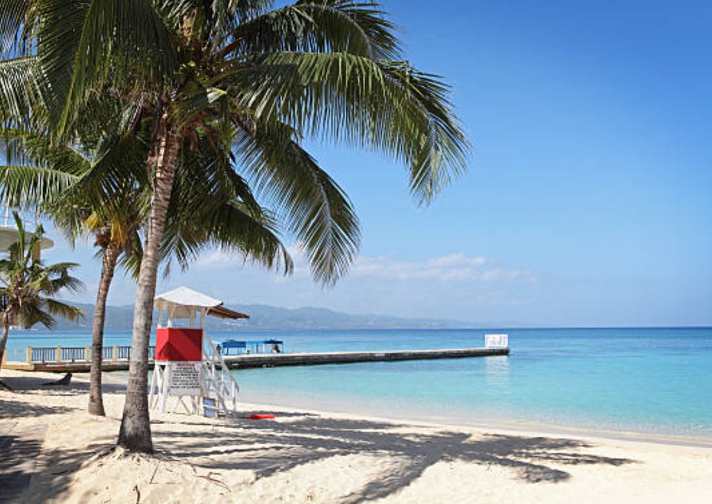 Doctor's Cave Beach in Montego Bay Jamaica with clear turquoise water and palm-lined shoreline near the cruise port
